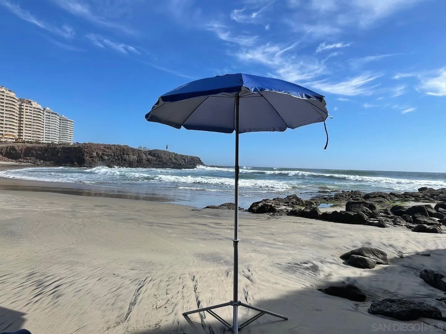 115 Carretera Libre Tijuana O'Neals, CA 93645 - Photo 8 of 62 a blue and white umbrella sitting in the ocean