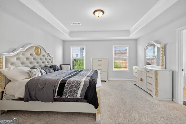 a bedroom with a large bed and a window