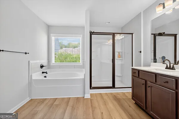 a bedroom with a bed and a large mirror