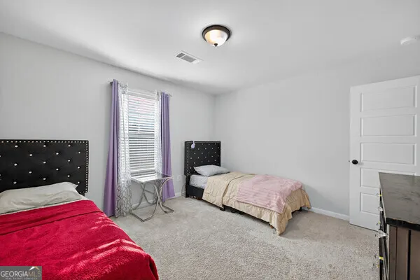 a bedroom with a large bed and a large window