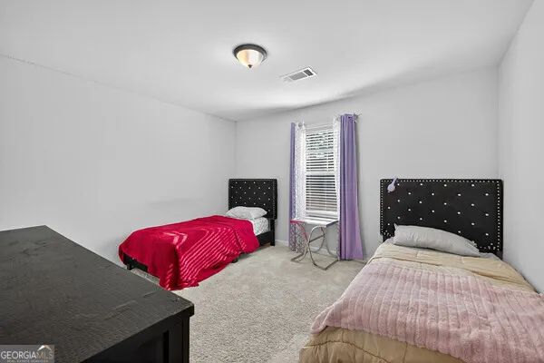 a bedroom with a bed and a desk