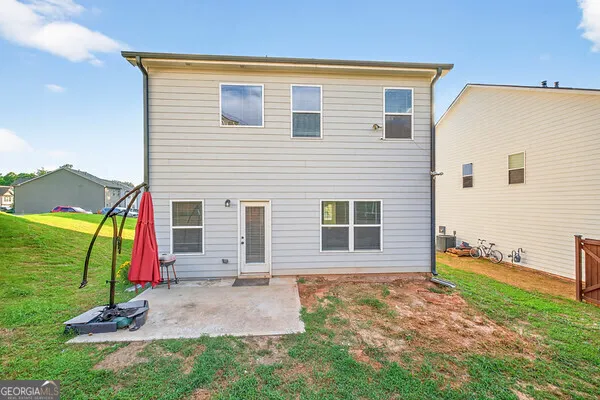 a aerial view of a house with swimming pool and large trees