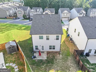 a view of multiple houses with yard