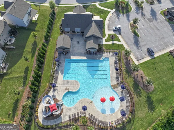a view of a house with a yard and potted plants