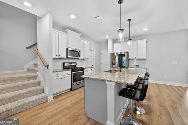 a kitchen with stainless steel appliances kitchen island a large island in the center