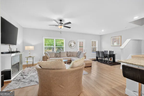 a living room with fireplace furniture and a flat screen tv