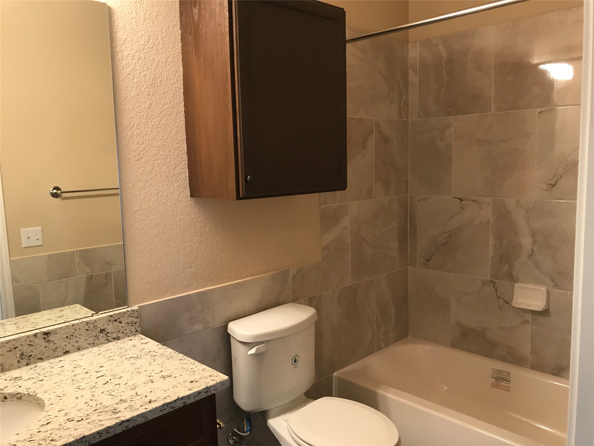 2507 Oak Lane, Unit A Georgetown, TX 78628 - Photo 10 of 11 Granite counters and tiled shower enclosure add elegance to this inviting bathroom.