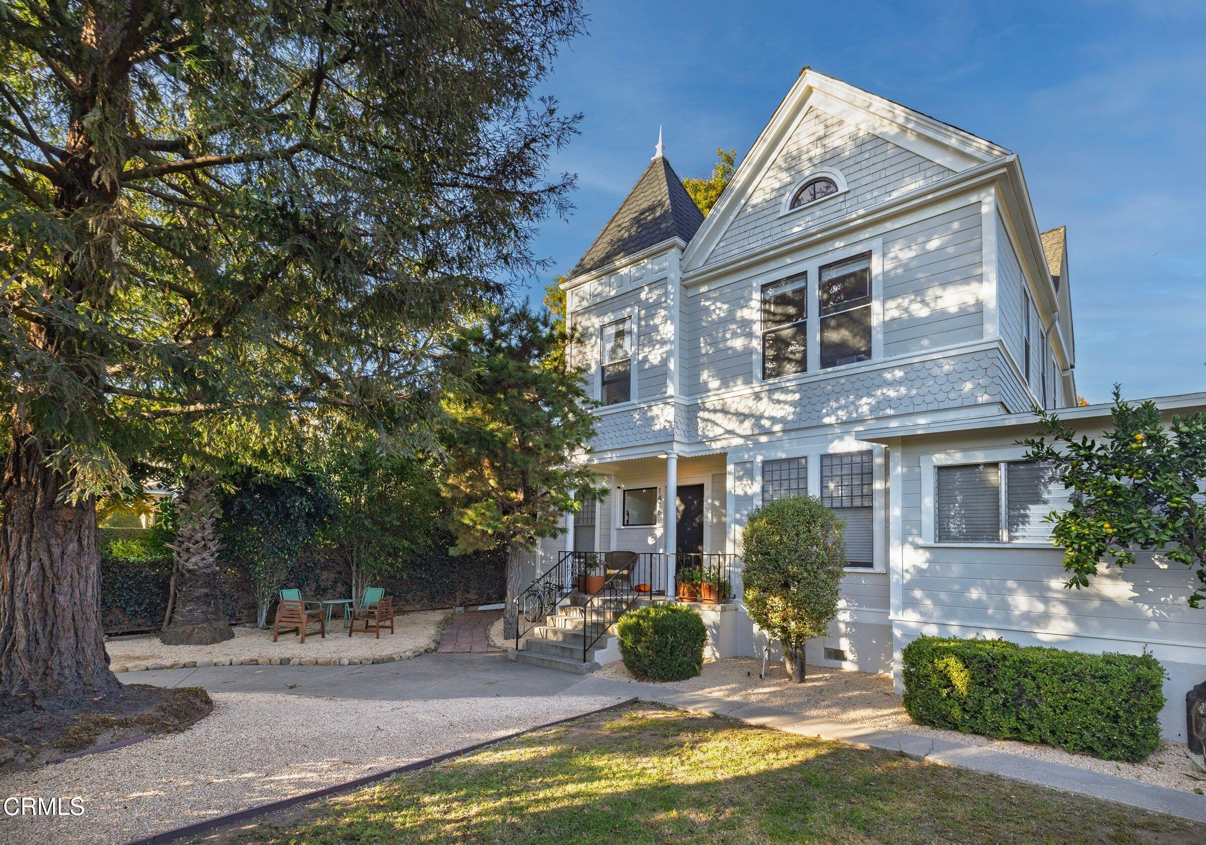 a view of a house with backyard porch and sitting area