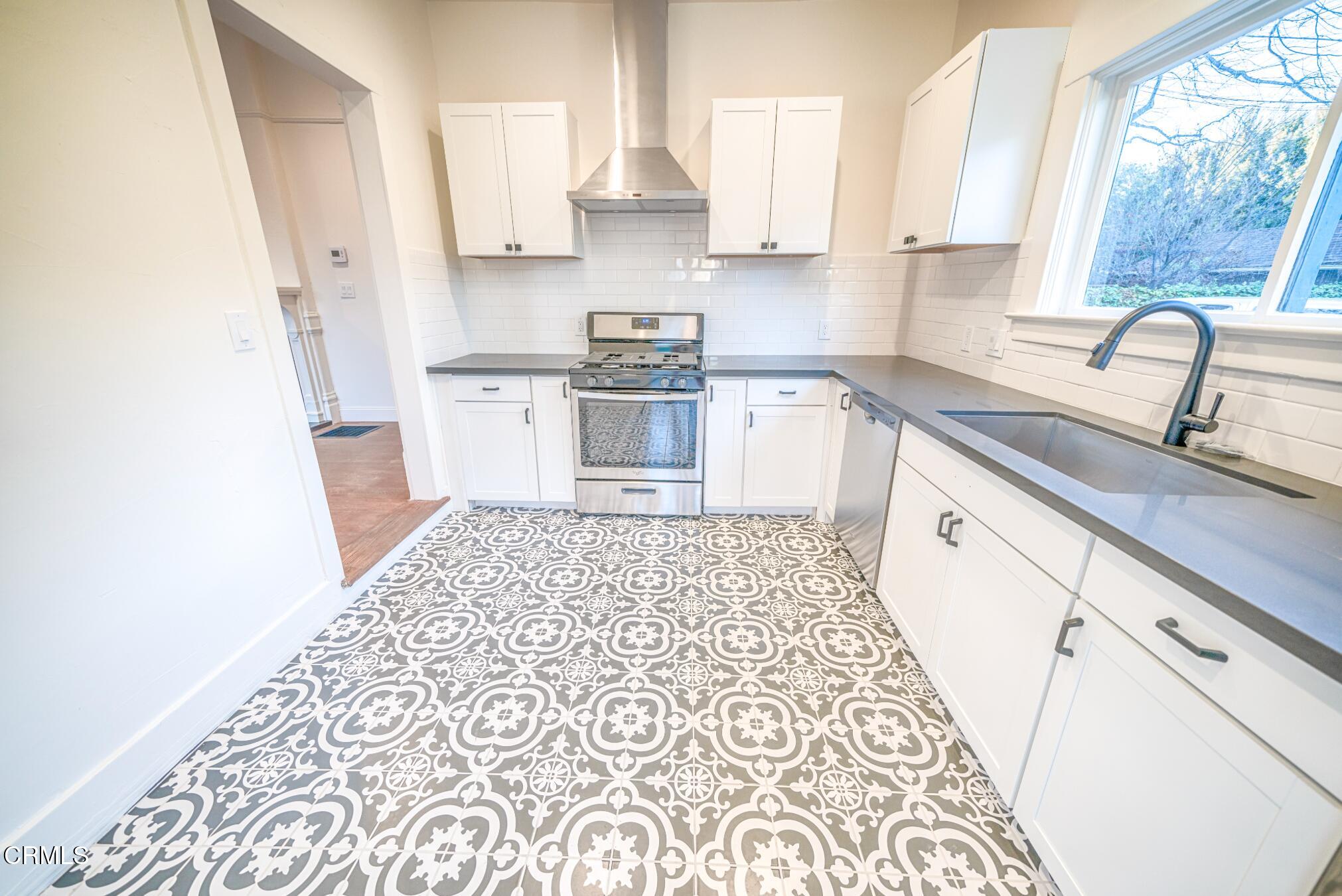 1416 Bath Street Santa Barbara, CA 93101 - Photo 12 of 15 a kitchen with a sink a stove a refrigerator and a window