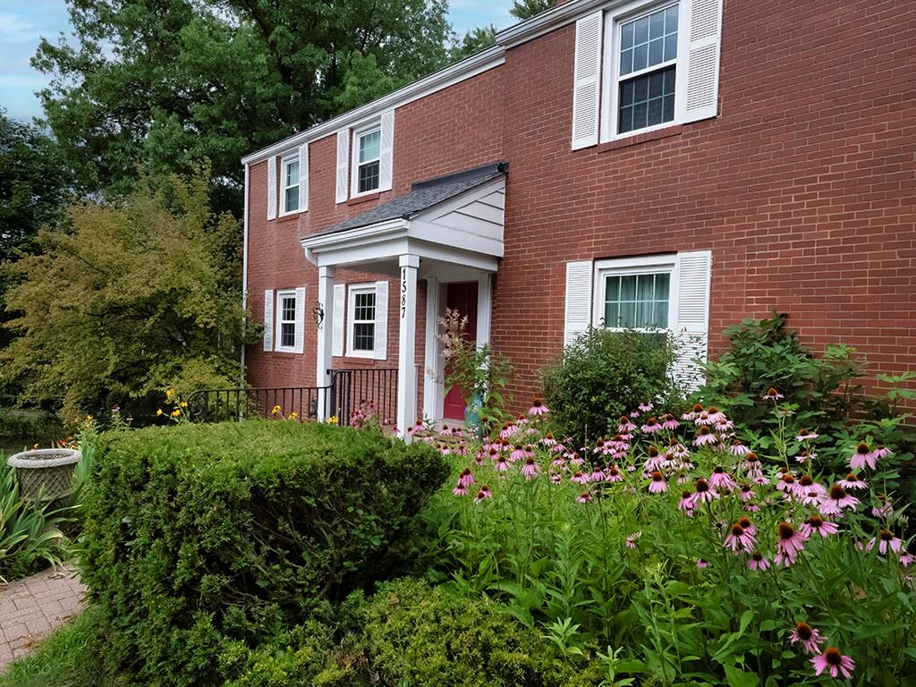 1587 Anderson Road Pittsburgh, PA 15209 - Photo 2 of 22 a view of a brick house with a flower garden