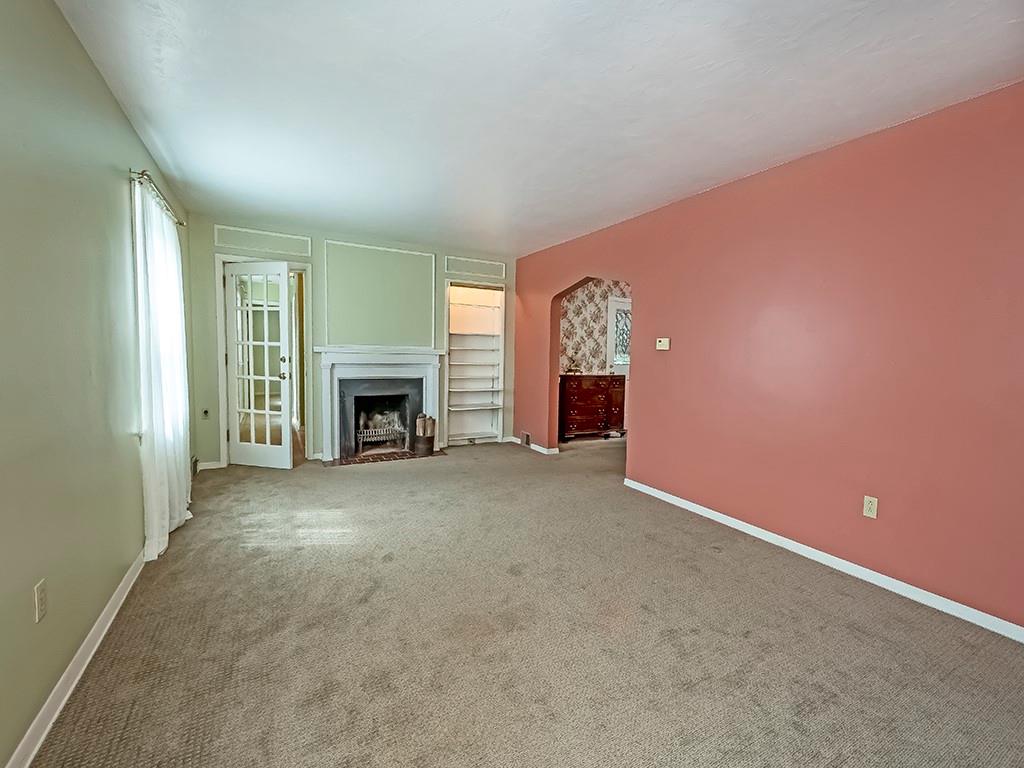 1587 Anderson Road Pittsburgh, PA 15209 - Photo 4 of 22 an empty room with fireplace and a window