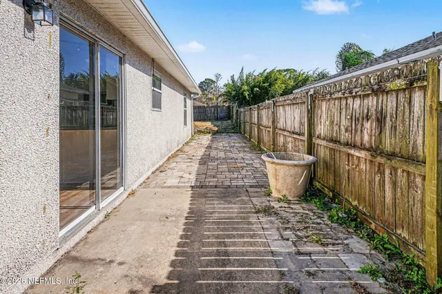 a view of a pathway with a wrought fence