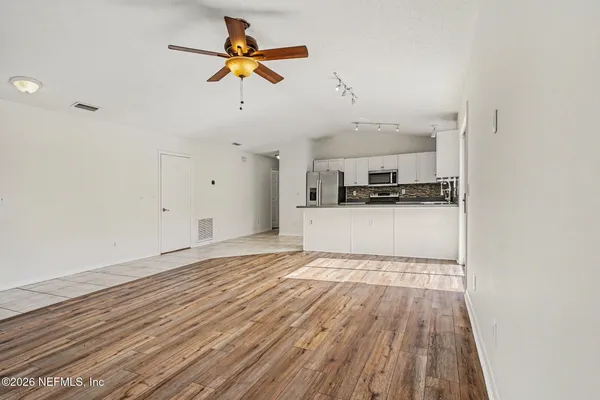 a view of a kitchen with microwave and cabinets