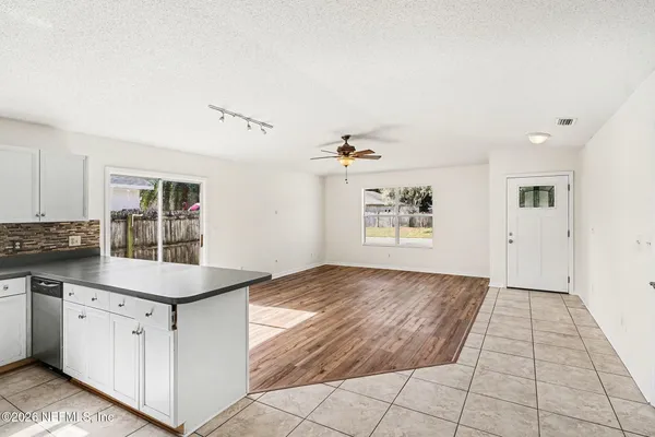 a kitchen with granite countertop a sink and cabinets