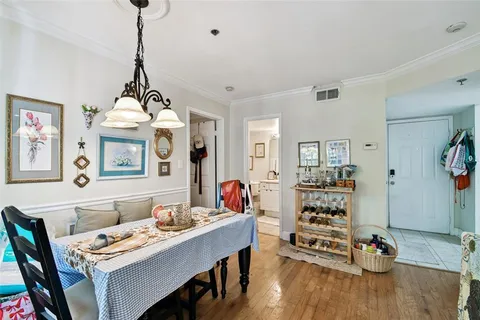 a bedroom with a bed and a flat tv screen on the dresser