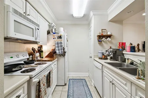 a kitchen with sink cabinets and stove