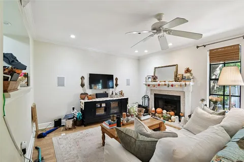 a living room with furniture fireplace and flat screen tv