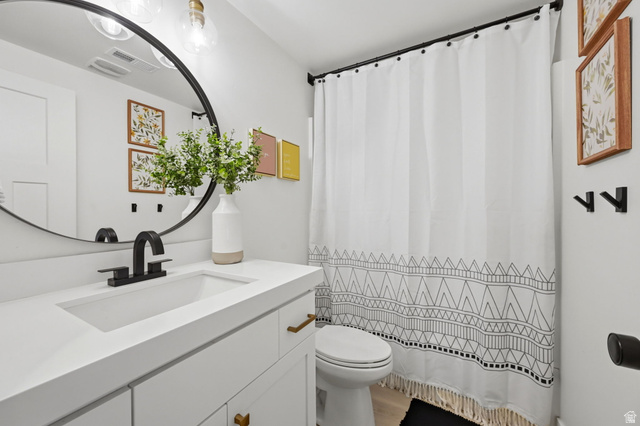57 McCall Ln. Farmington, UT 84025 - Photo 27 of 36 Modern bathroom featuring a white vanity with brass-tone hardware and an integrated sink