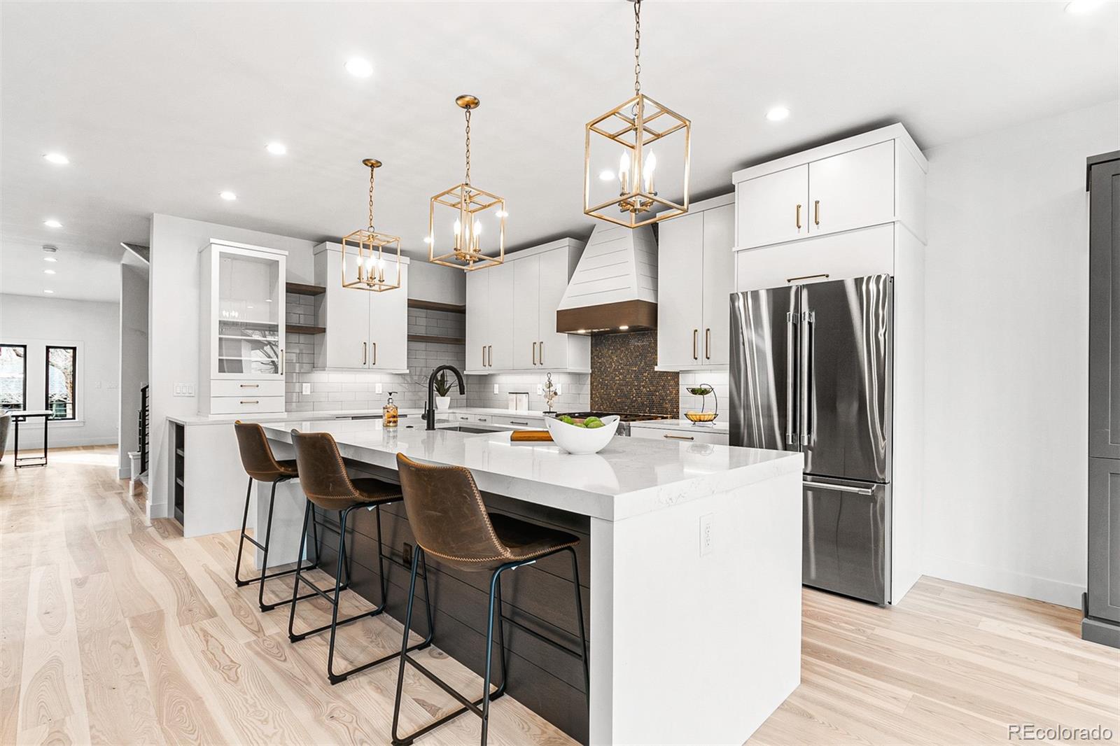 732 South Gilpin Street Denver, CO 80209 - Photo 19 of 40 a kitchen with stainless steel appliances kitchen island granite countertop a refrigerator a stove a sink dishwasher a dining table and chairs with wooden floor
