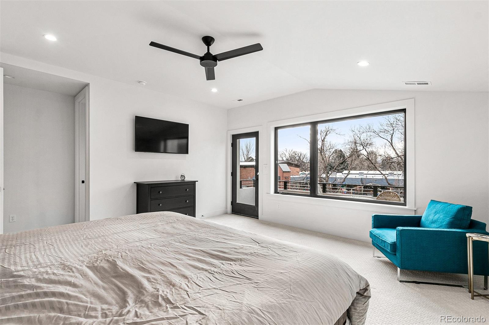 732 South Gilpin Street Denver, CO 80209 - Photo 25 of 40 a bedroom with a large bed a flat screen tv and a couch