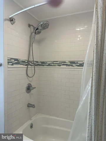 a bathroom with a shower and a shower
