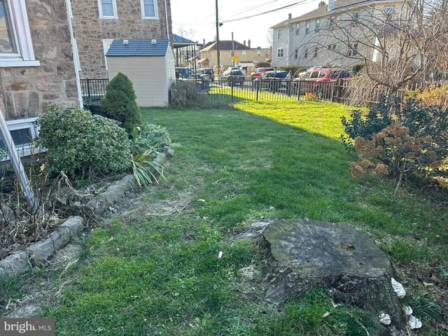 a patio with table and chairs and potted plants