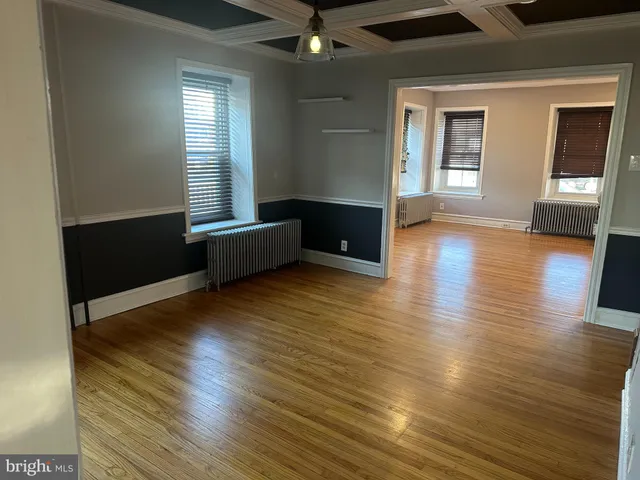 a living room with hard wood floors and a wooden floors