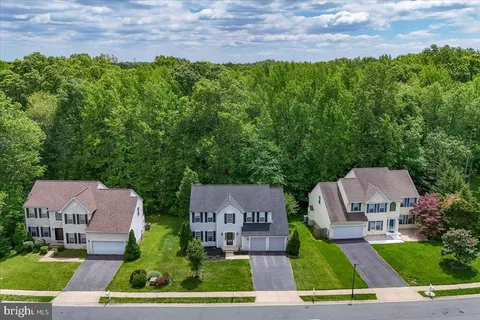an aerial view of multiple houses with a yard