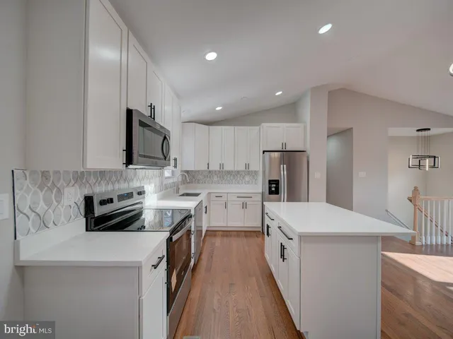 a kitchen with stainless steel appliances a stove sink microwave and refrigerator