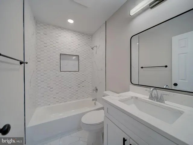 a bathroom with a sink toilet and mirror