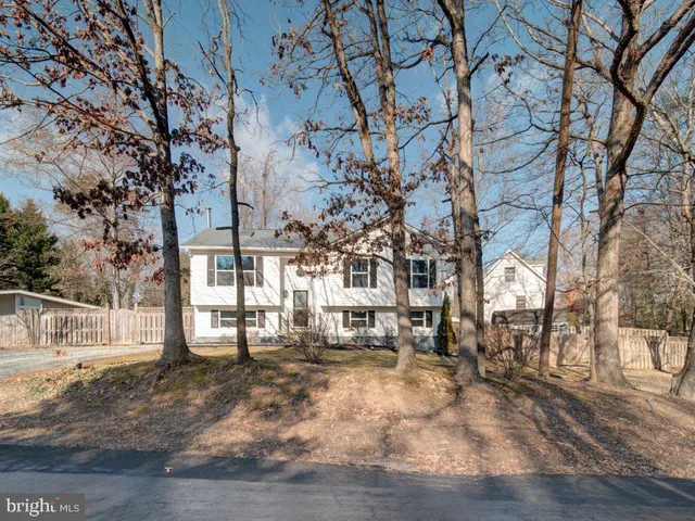 a front view of a house with a yard covered in snow