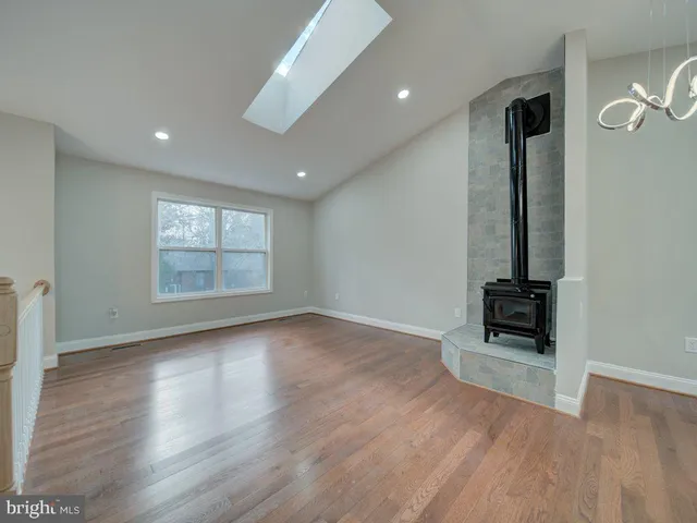 an empty room with windows and brick walls