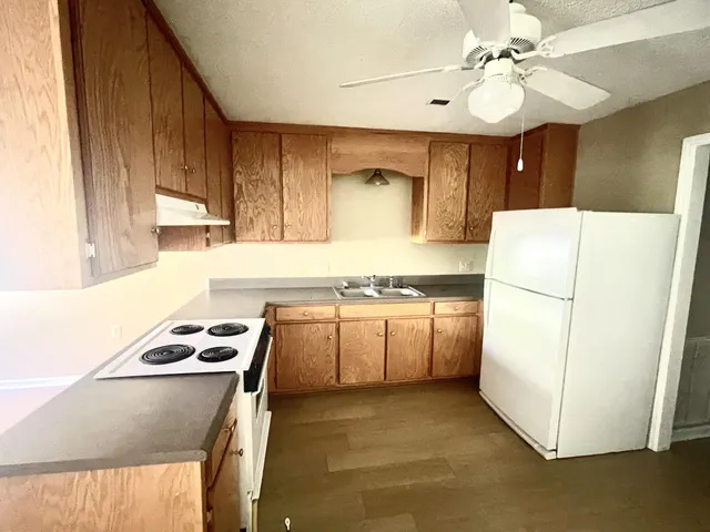 a kitchen with a refrigerator and a sink