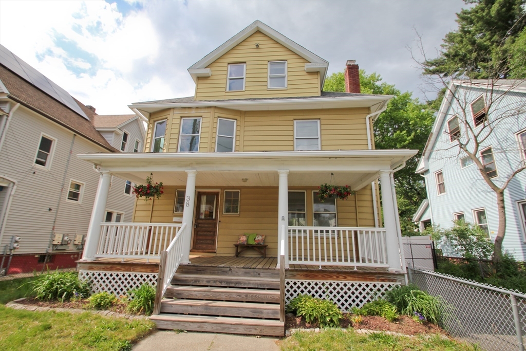 38 Virginia Street Springfield, MA 01108 - Photo 42 of 42 a view of a brick house with large windows and a fence