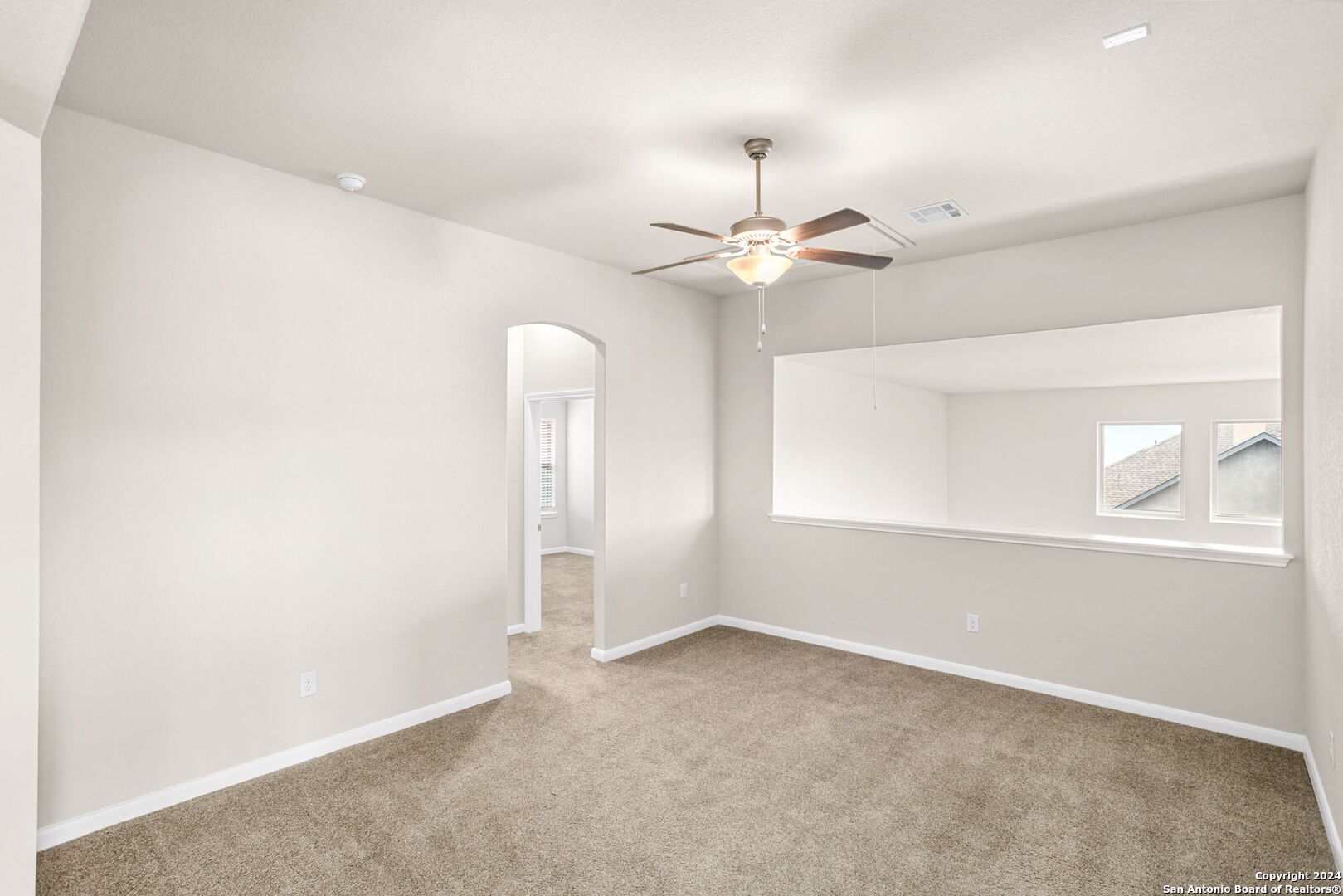 116 Escondido Boerne, TX 78006 - Photo 11 of 16 an empty room with a chandelier fan and windows