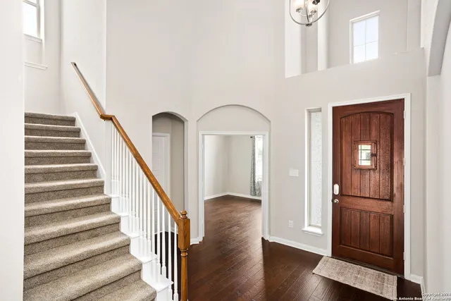 a view of entryway with wooden floor and stairs