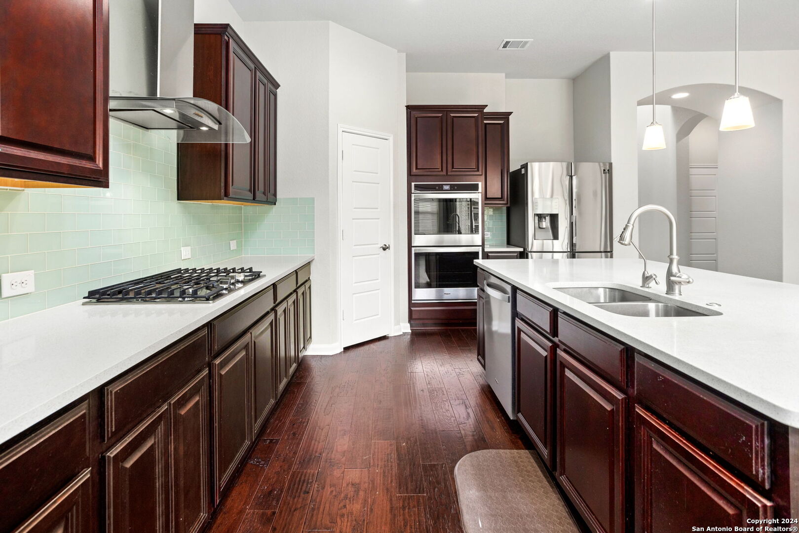 116 Escondido Boerne, TX 78006 - Photo 6 of 16 a kitchen with stainless steel appliances a sink stove and refrigerator