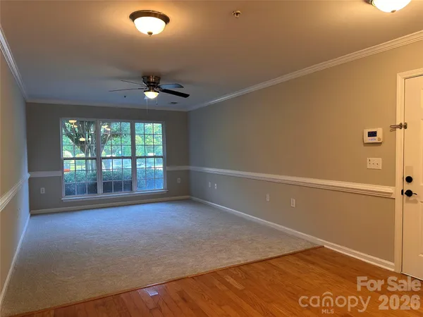 en empty room with window and ceiling fan