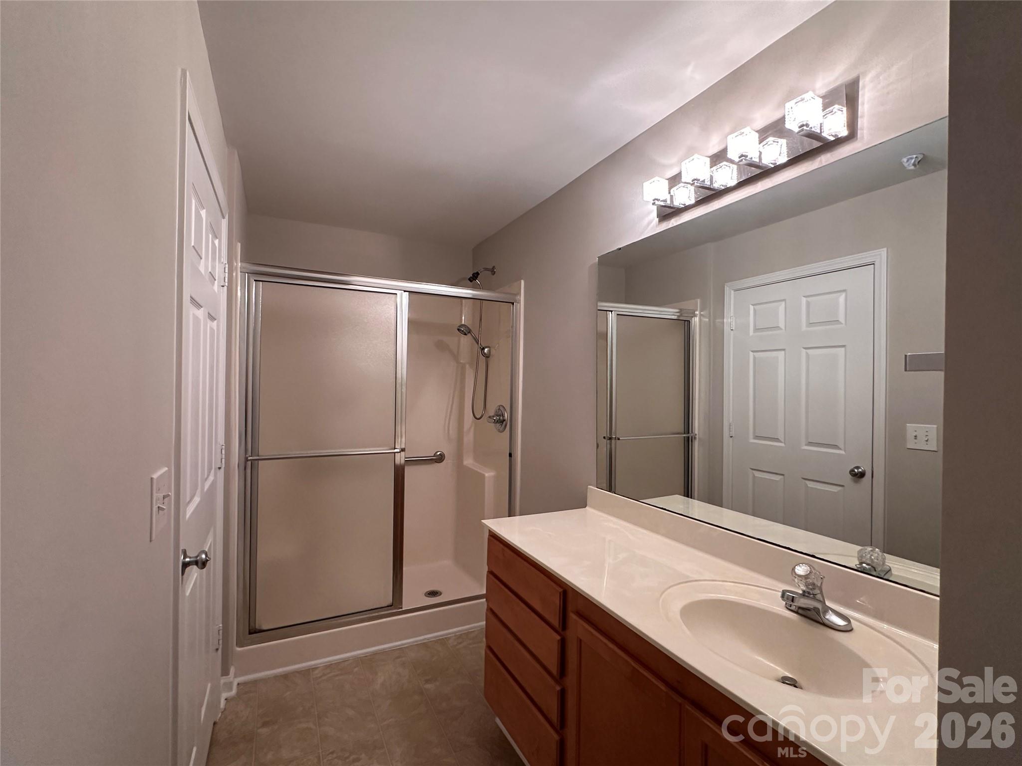 5236 Hilltop Road Jamestown, NC 27282 - Photo 22 of 32 a bathroom with a sink vanity and a mirror