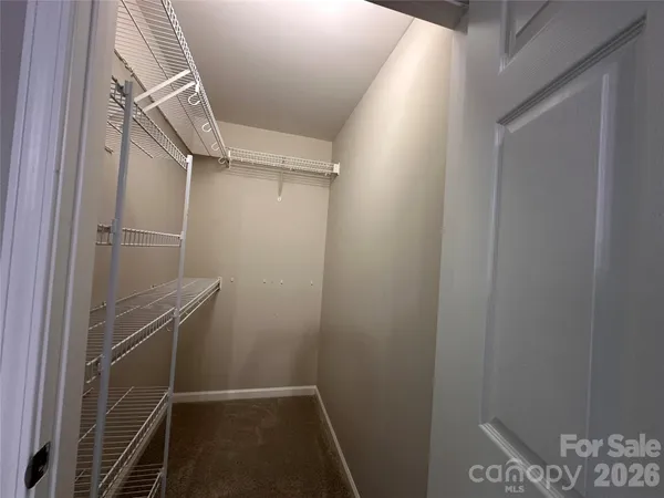 a view of a car parked in front of a brick house