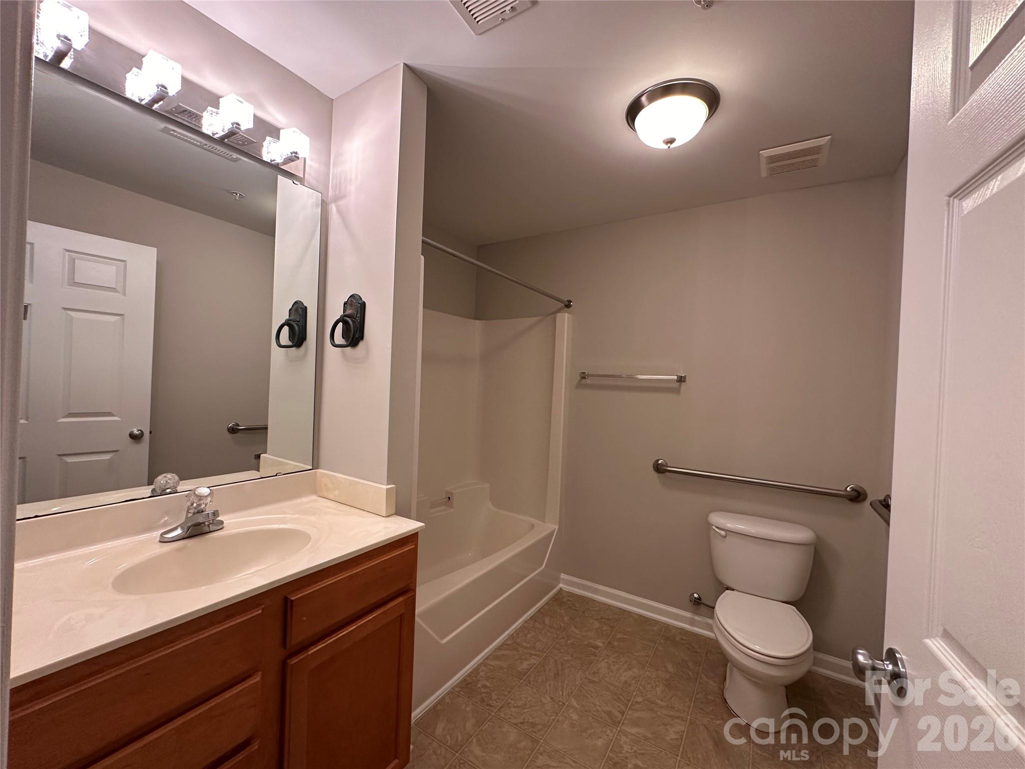 5236 Hilltop Road Jamestown, NC 27282 - Photo 26 of 32 a bathroom with a toilet sink and mirror