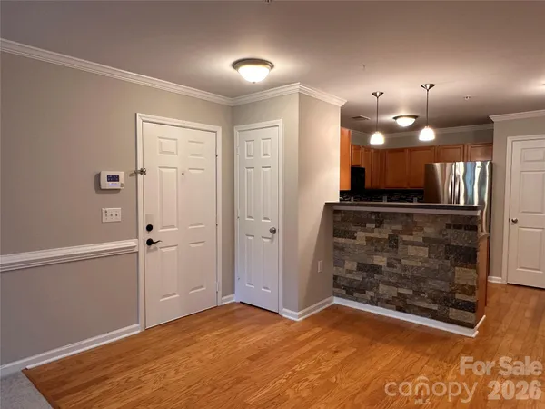 a kitchen with granite countertop a refrigerator and a sink
