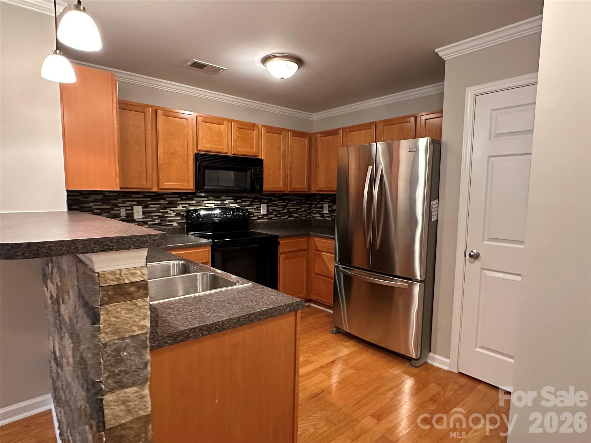 5236 Hilltop Road Jamestown, NC 27282 - Photo 8 of 32 a kitchen with granite countertop a refrigerator and a sink