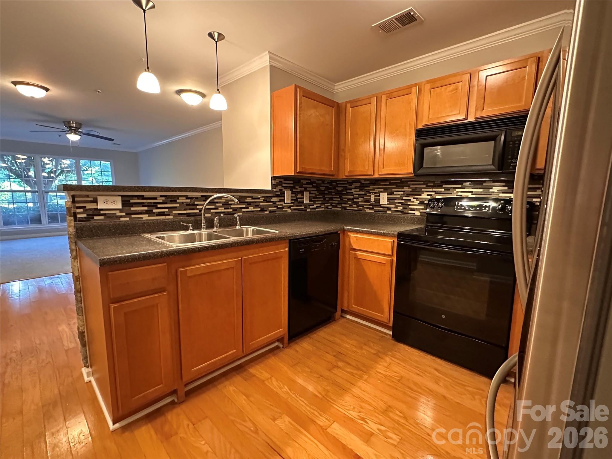 5236 Hilltop Road Jamestown, NC 27282 - Photo 9 of 32 a kitchen with stainless steel appliances granite countertop a stove a sink and a microwave