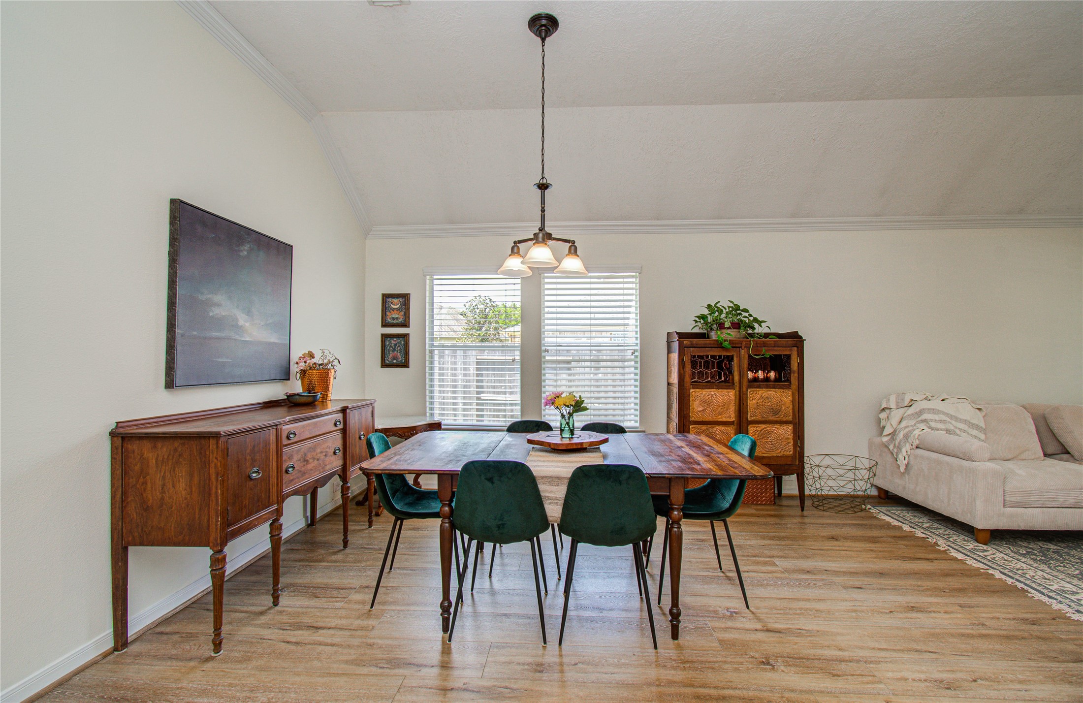 20007 Alcea Court Spring, TX 77379 - Photo 6 of 36 Bright dining area with a wooden table, elegant chairs, and classic furniture. Features high ceilings, light wood flooring, and ample natural light from large windows. Cozy, inviting atmosphere ideal for gatherings.