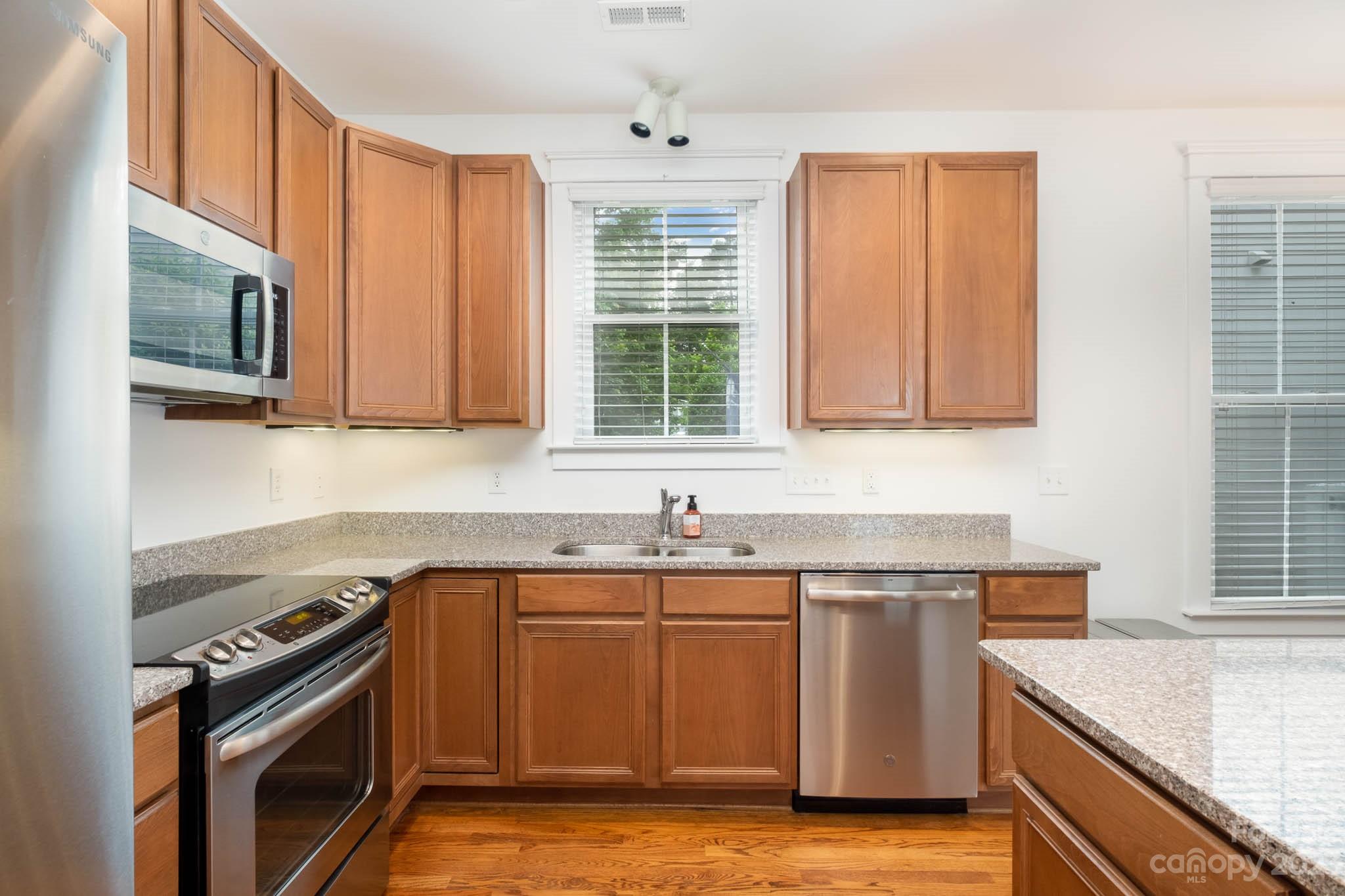 3499 Richard's Crossing Fort Mill, SC 29708 - Photo 13 of 33 a kitchen with stainless steel appliances granite countertop a sink stove and microwave