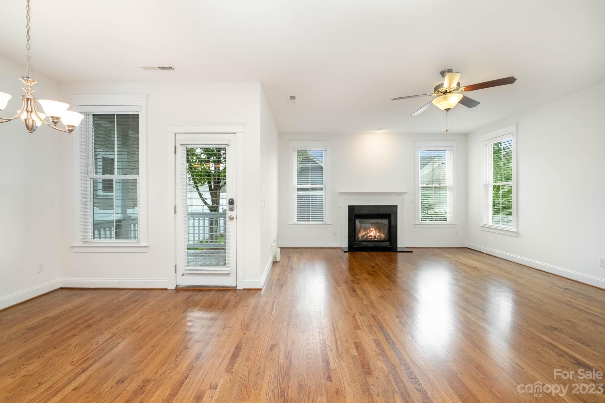 3499 Richard's Crossing Fort Mill, SC 29708 - Photo 7 of 33 an empty room with wooden floor fireplace and windows