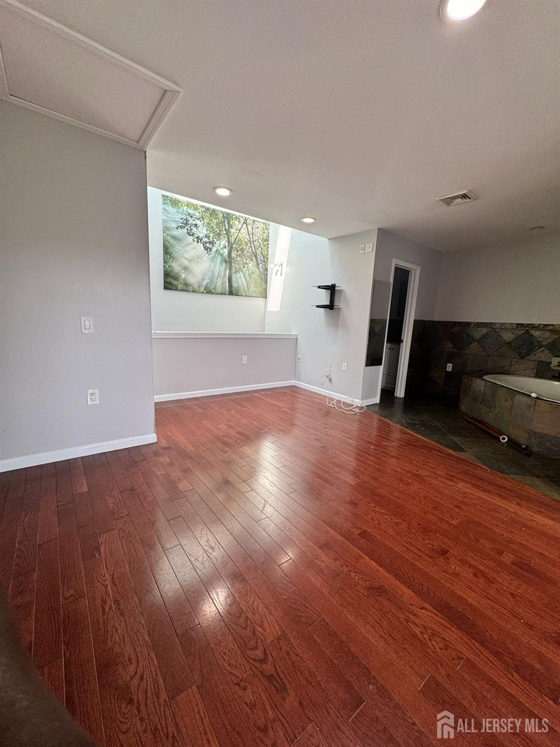 16 Jaques Street, Unit 22 Elizabeth, NJ 07201 - Photo 12 of 27 wooden floor in an empty room with a window