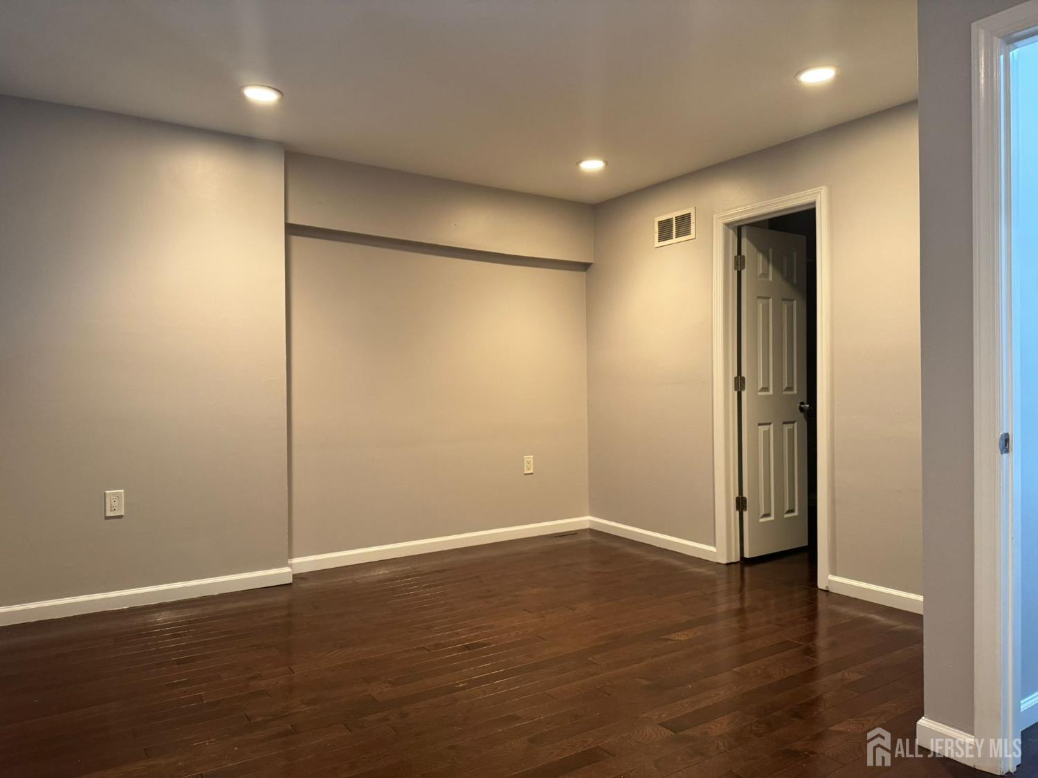 16 Jaques Street, Unit 22 Elizabeth, NJ 07201 - Photo 15 of 27 an empty room with wooden floor and closet