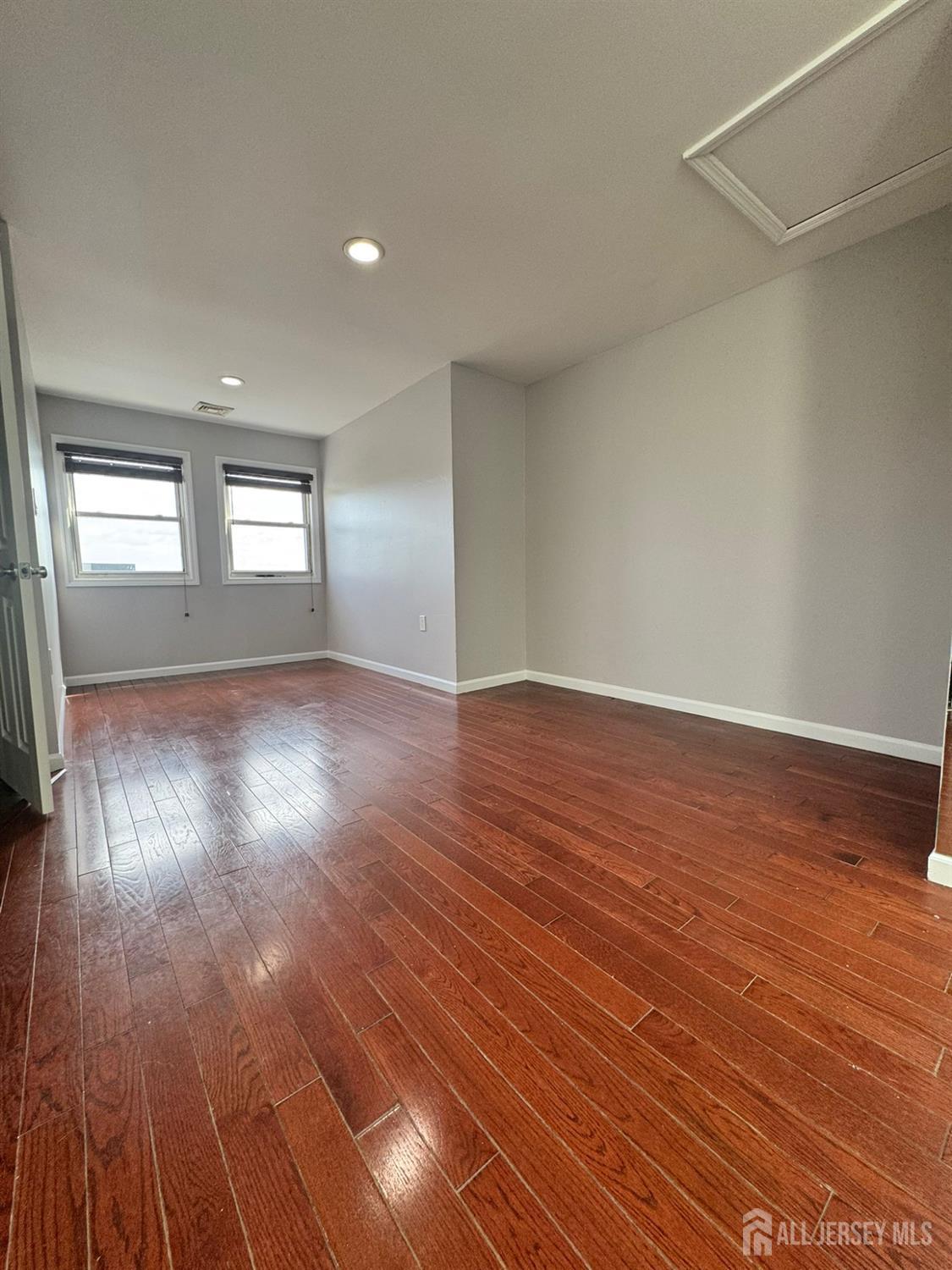 16 Jaques Street, Unit 22 Elizabeth, NJ 07201 - Photo 21 of 27 wooden floor in an empty room with a window